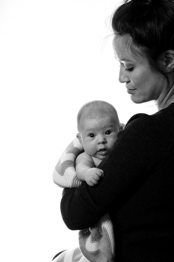 Mother and baby in studio, soft light.