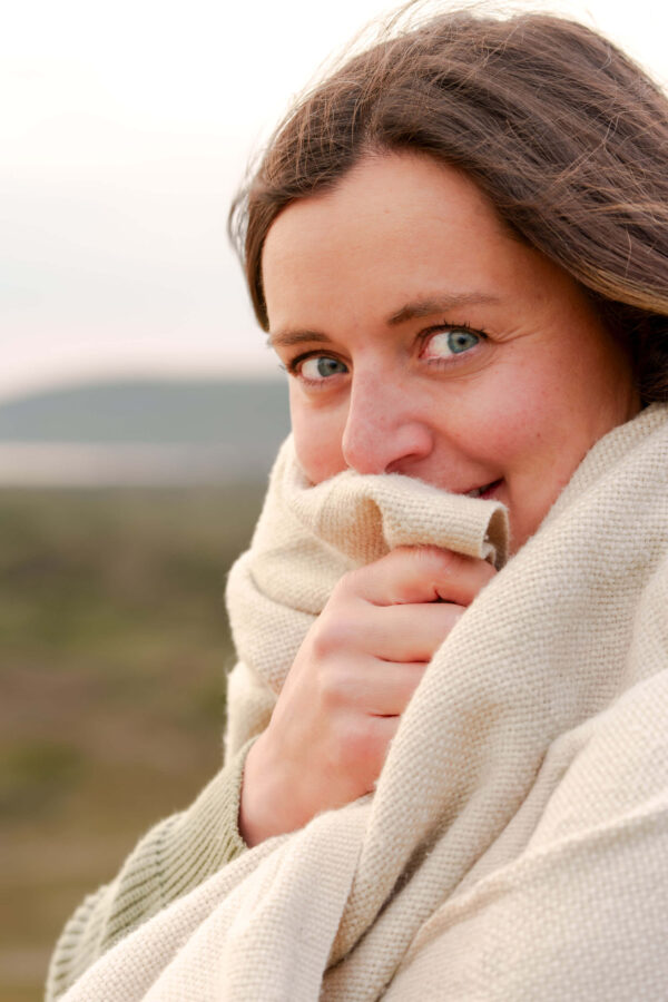 Family portrait of Fi on a beach, sharing an intimate, natural moment in soft light.
