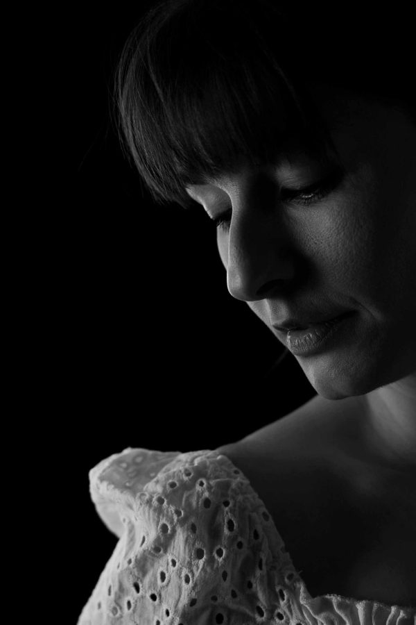 Black-white portrait, head and right shoulder, elegant.