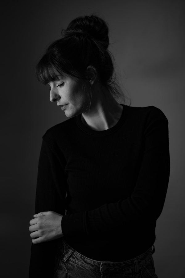 Black-and-white portrait of a woman in studio.