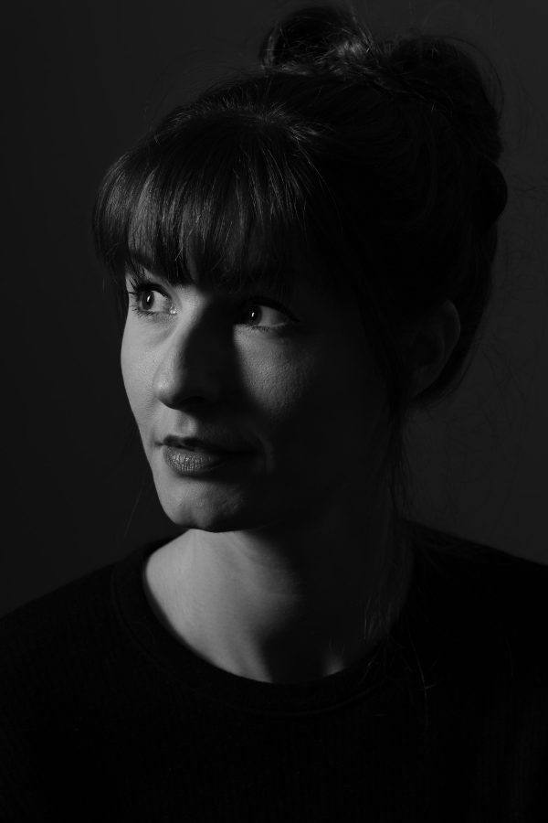 Black and white portrait, head and shoulders. Elegant soft light across face.