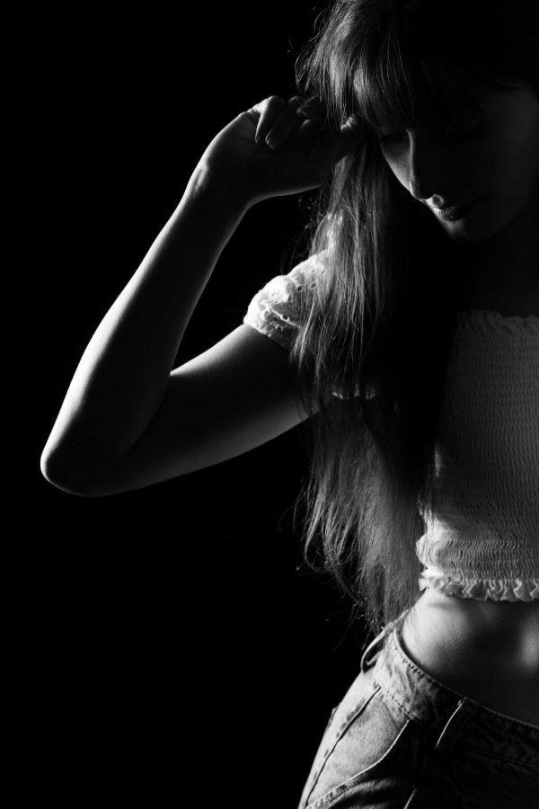 Portrait of a woman artistically framed in a frame with a black background.