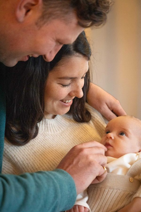 Mother, father, and baby at Christmas.