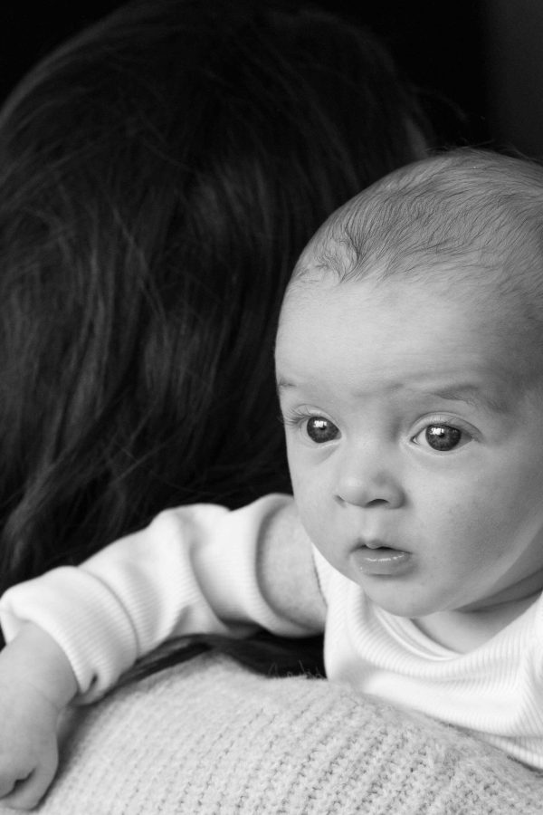 Baby over mother's shoulder.