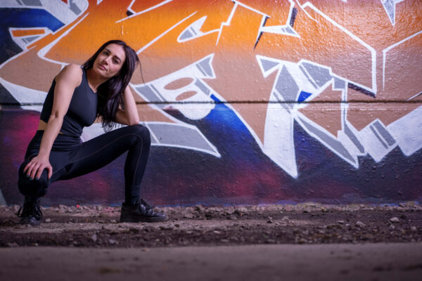 Portrait of a model in an urban street setting with graffiti background