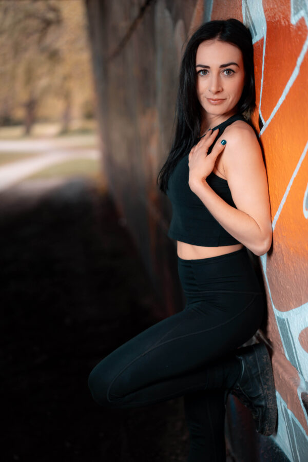 Portrait of a model in an urban street setting with graffiti background
