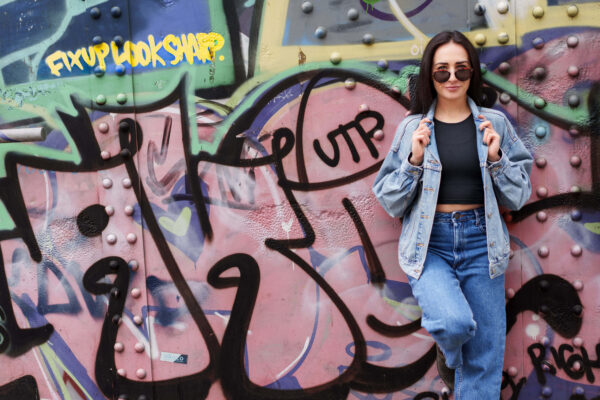 Portrait of a dancer in an urban street setting with graffiti background